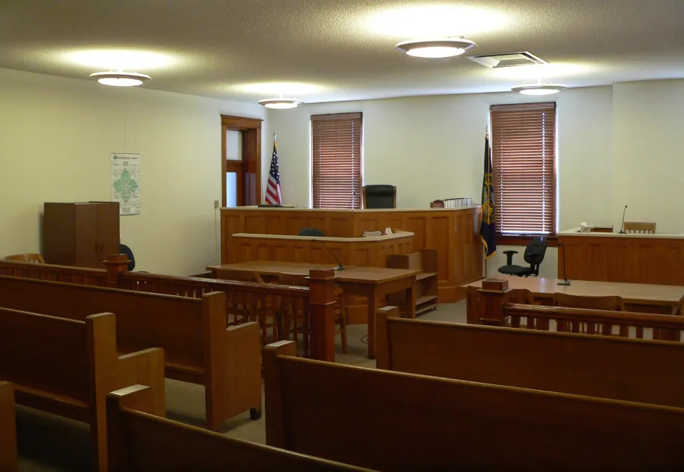 Courtroom with the judge's bench and wooden pews