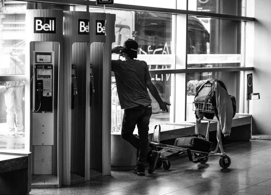 Person making a call from a row of public payphones