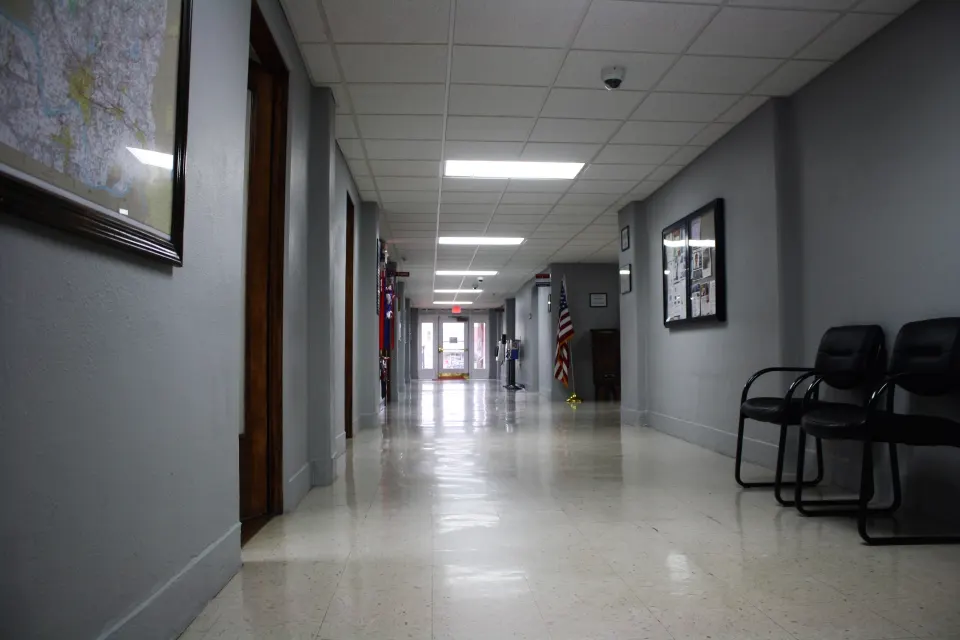 Long, quiet hallway inside a county courthouse